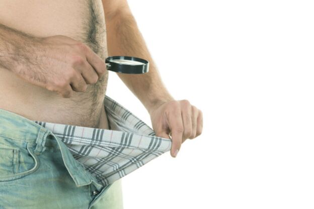 Un uomo guarda il suo pene e vuole ingrandirlo